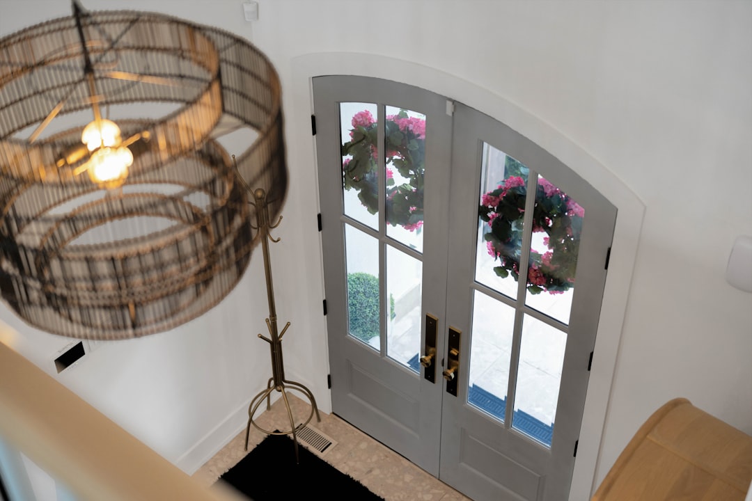 Entryway with double doors, wreaths, and a large decorative chandelier