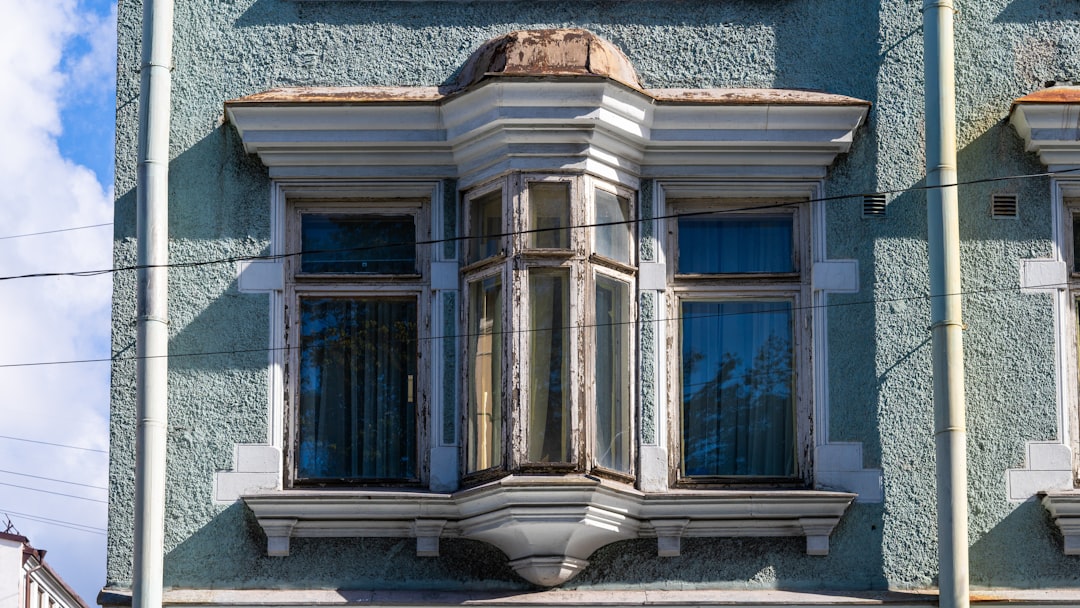 Ornate bay window on a light blue building facade