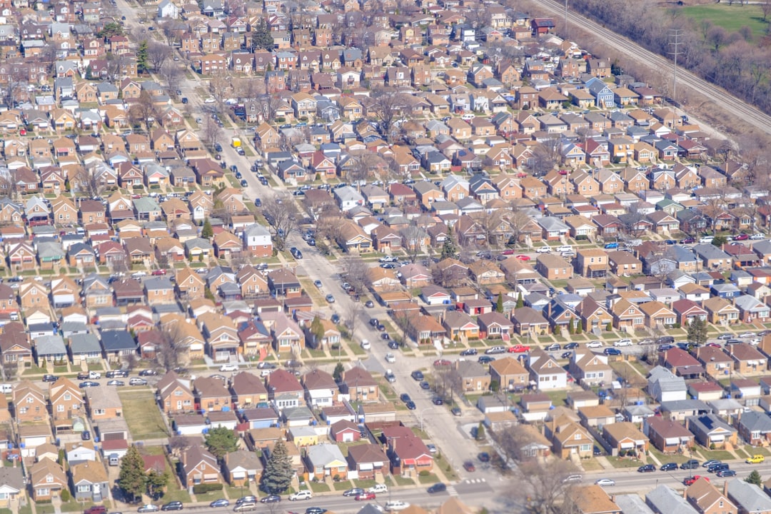 An aerial view of a dense residential neighborhood with many small detached houses