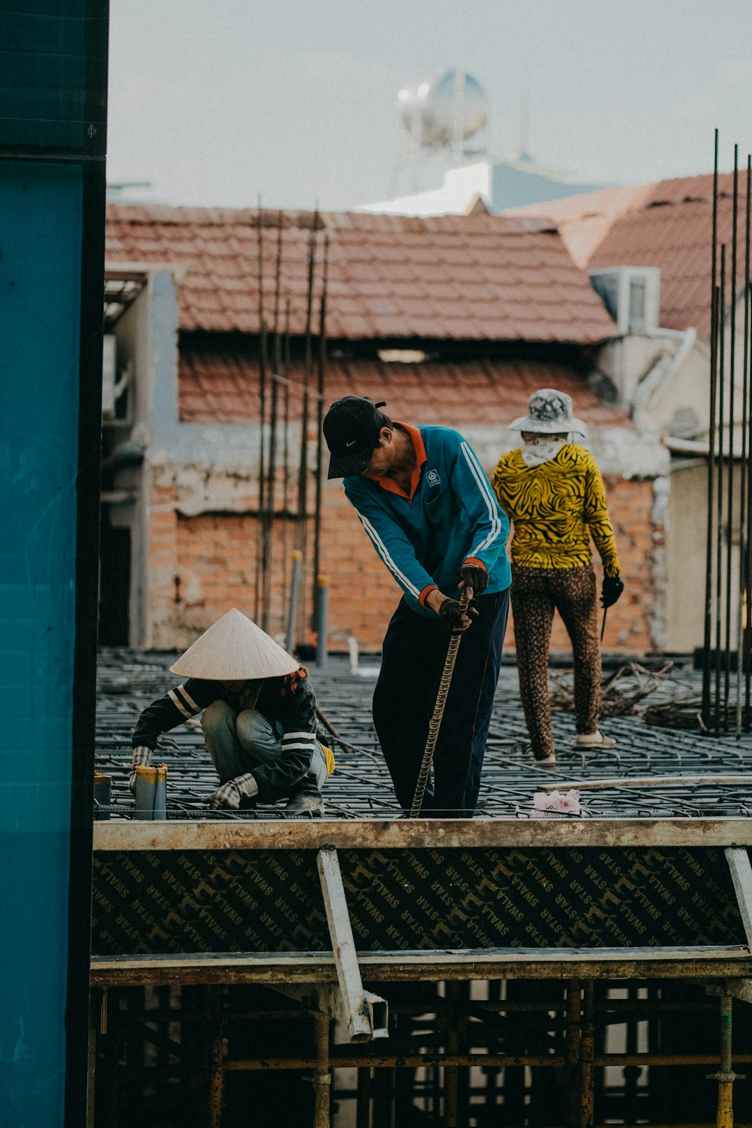 f20af157dcd74f24ab05931bc379a668 two men are working on a construction site