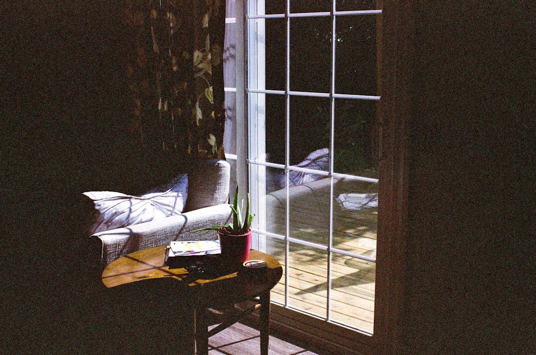 fc13ea36da864338bb3e76773cd8e6dc a couch sitting next to a window in a room