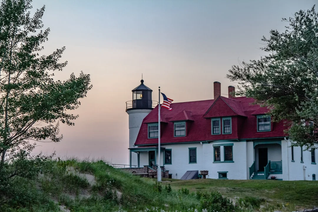 Lighthouse and Red Roof Building a large white house with a red roof