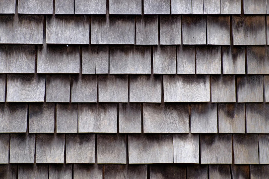 Close-up of overlapping wooden shingles arranged in horizontal rows