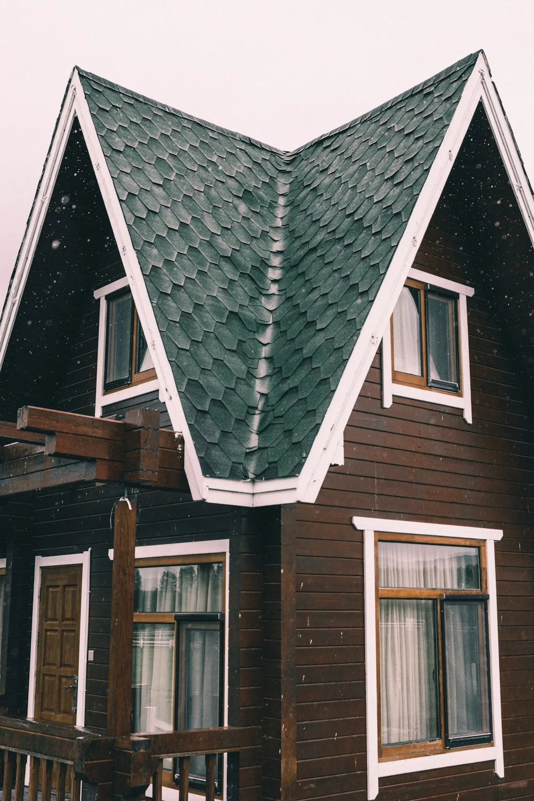 Distinctive Green Shingled Roof gray and brown wooden house