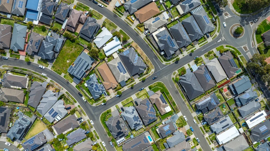 Aerial view of a suburban neighborhood with houses and streets.