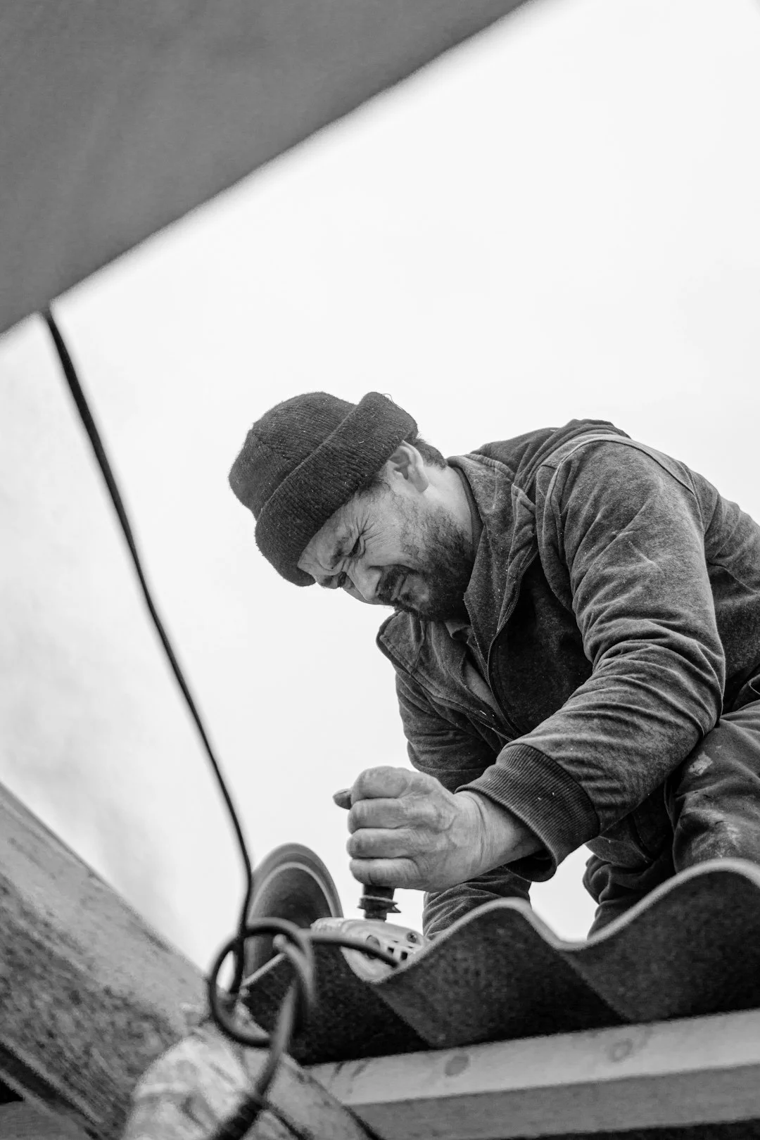 a man sitting on top of a skateboard on top of a roof