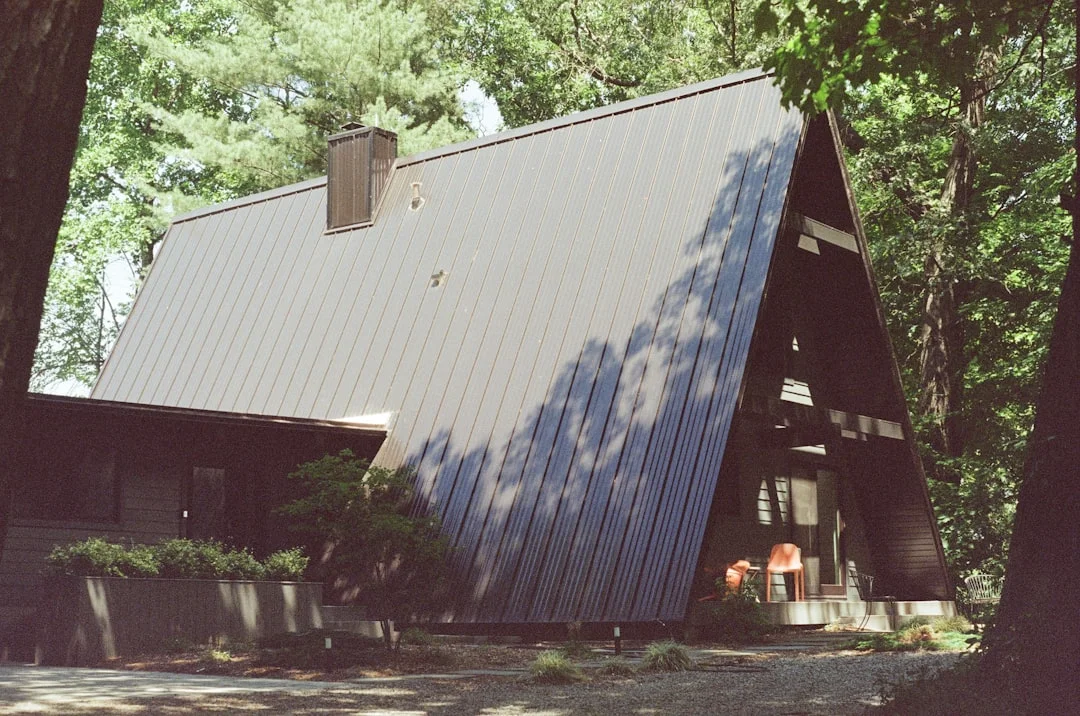 A-Frame House with Metal Roof A house in the woods with a metal roof