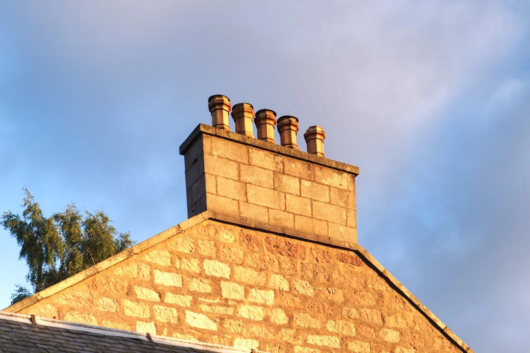 Stone Building with Chimney a brick chimney on top of a building