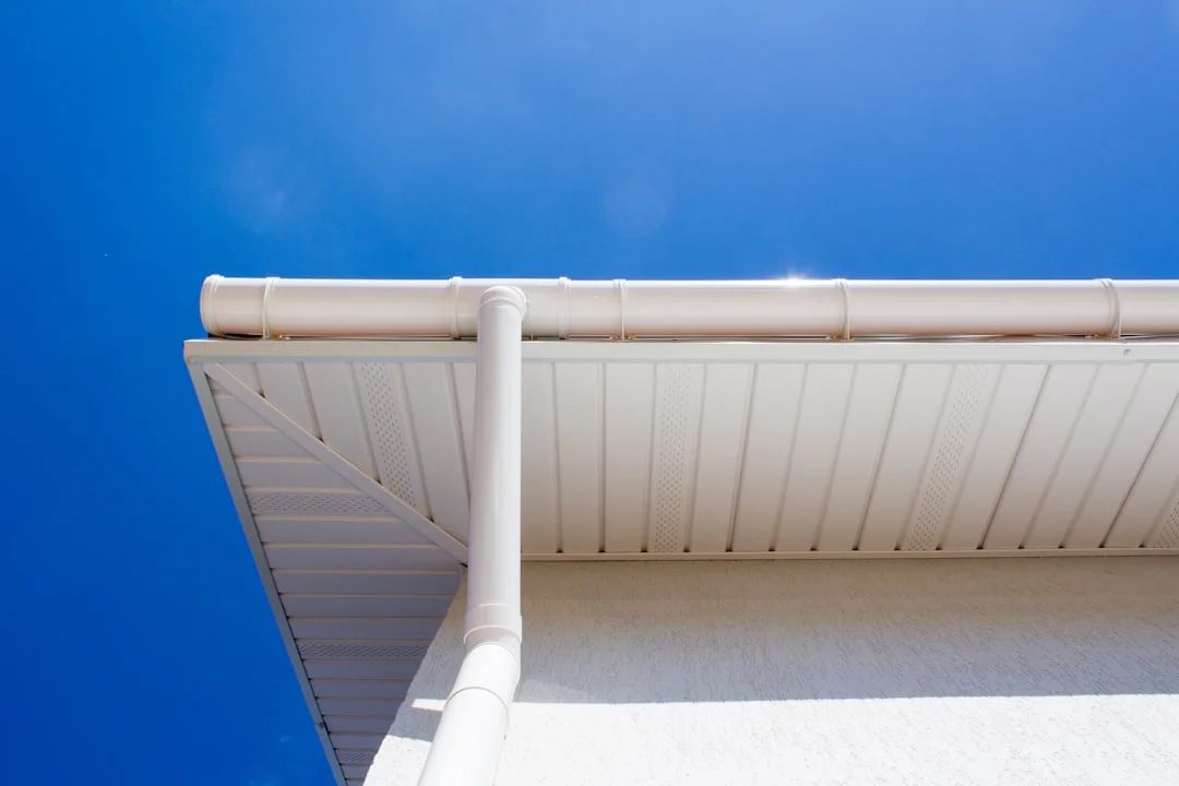 Gutter Installation Detail white PVC tube under blue sky