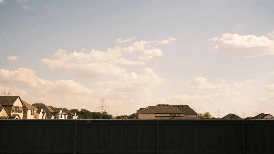 Suburban houses under a cloudy sky.