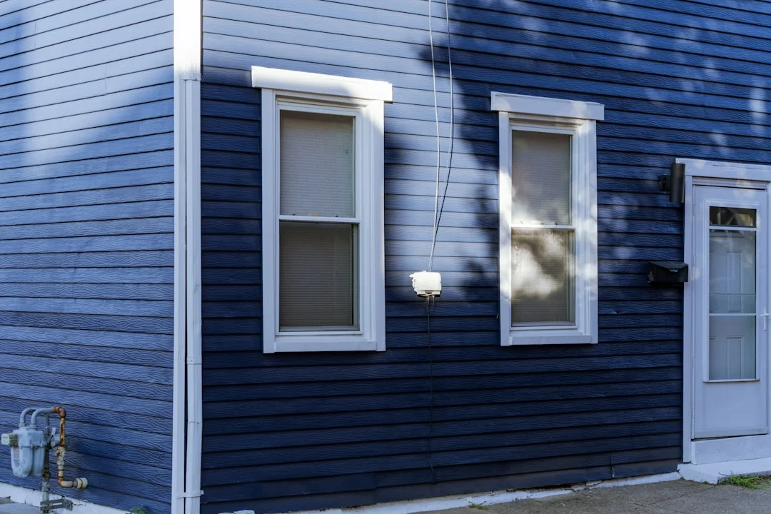 A blue house with a white door and windows